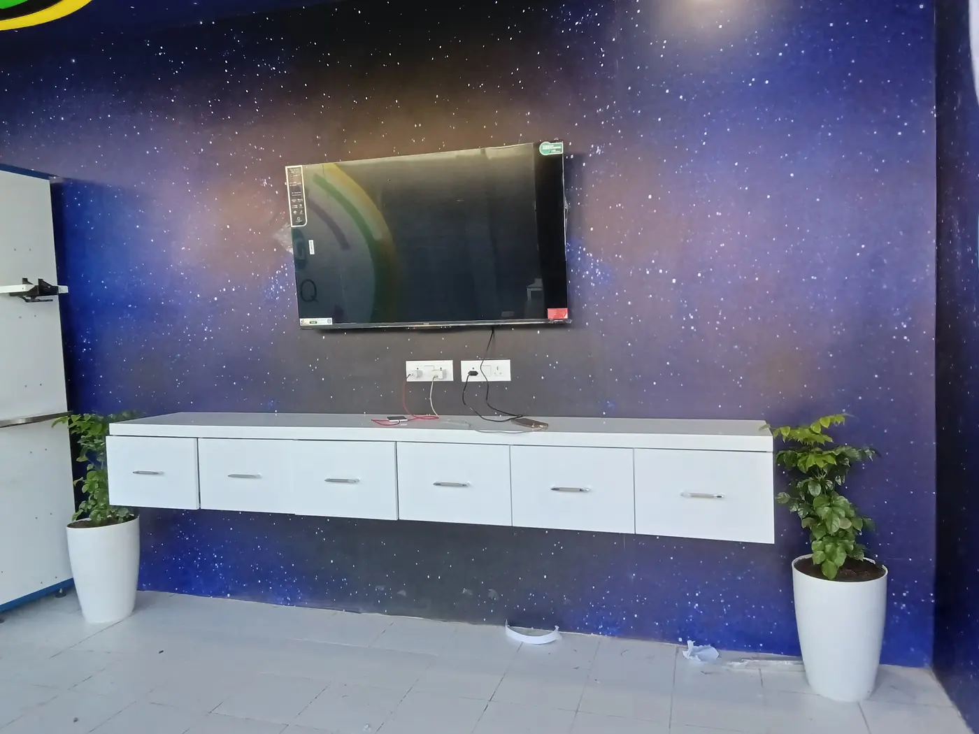 Completed media wall with custom cabinetry and branded finish